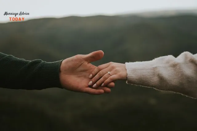 Couple's hands reaching for each other - best marriage advice