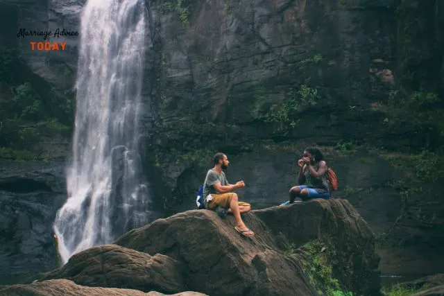 Couple enjoying time in outdoors in front of waterfall - what to look for in a relationship